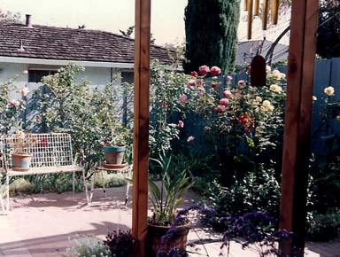 From the shade of the arbor, the garden invites.