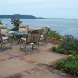 Red bricks visually divide the patio and echo the retaining wall.